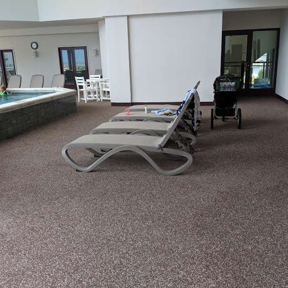 Pool deck with EverStone Flex flooring and lounge chairs.