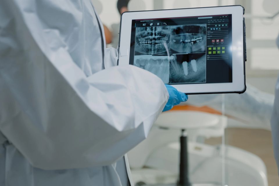 An orthodontist reviewing an x-ray