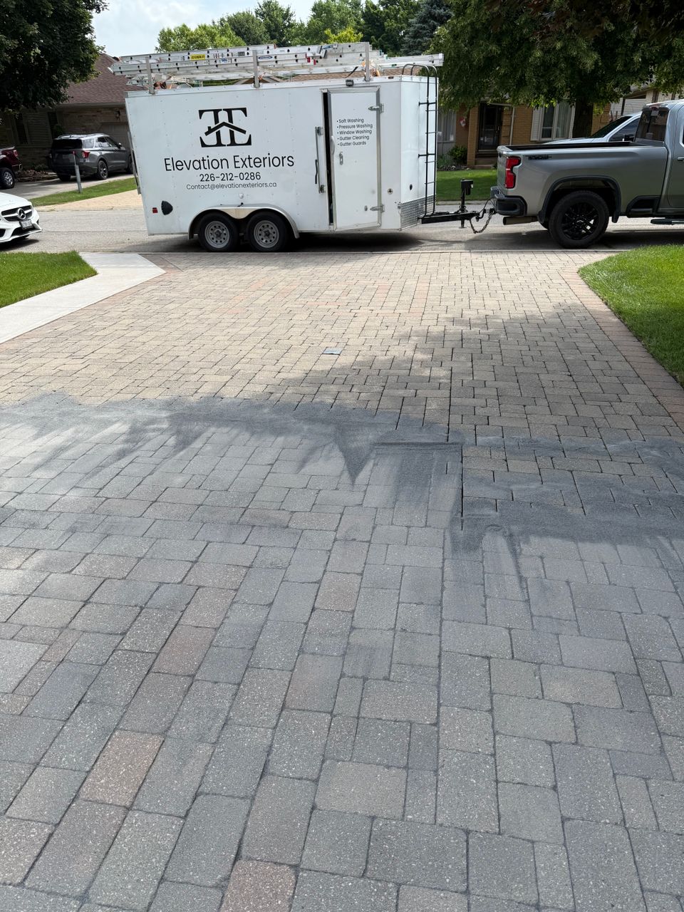 Polymeric sand swept into interlock driveway pavers after interlock cleaning with Elevation Exteriors trailer in Tillsonburg ON