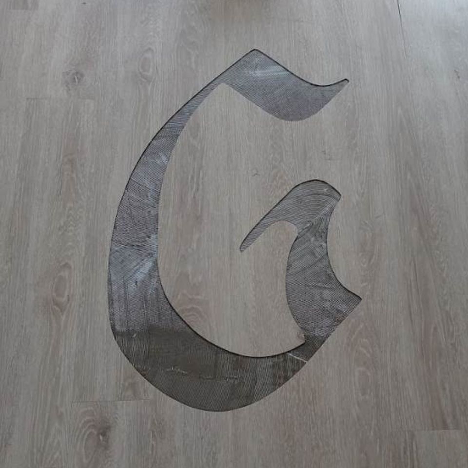 Custom dark flooring design set into a light wood-look floor.