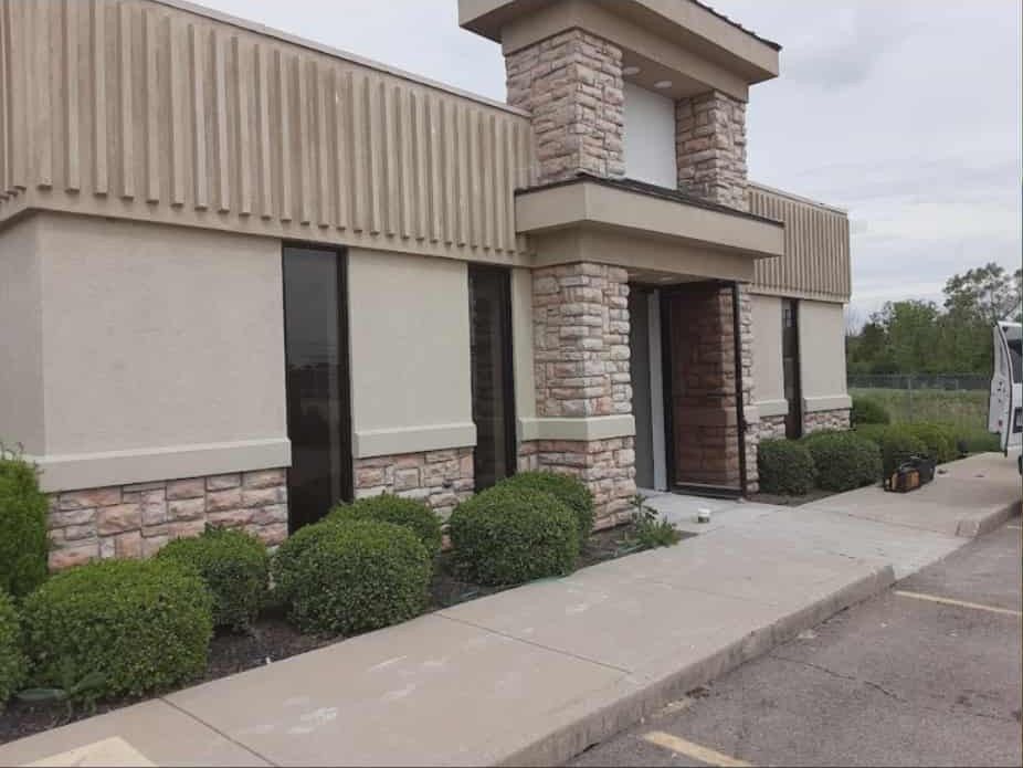 Commercial building featuring decorative veneer stone columns and exterior accents.