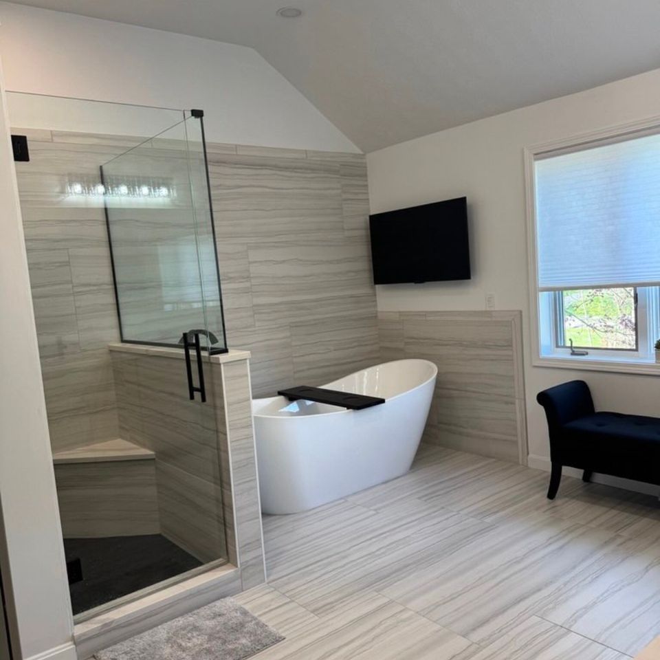 Primary bathroom remodel with freestanding soaking tub and walk-in glass shower in a Cleveland east side home