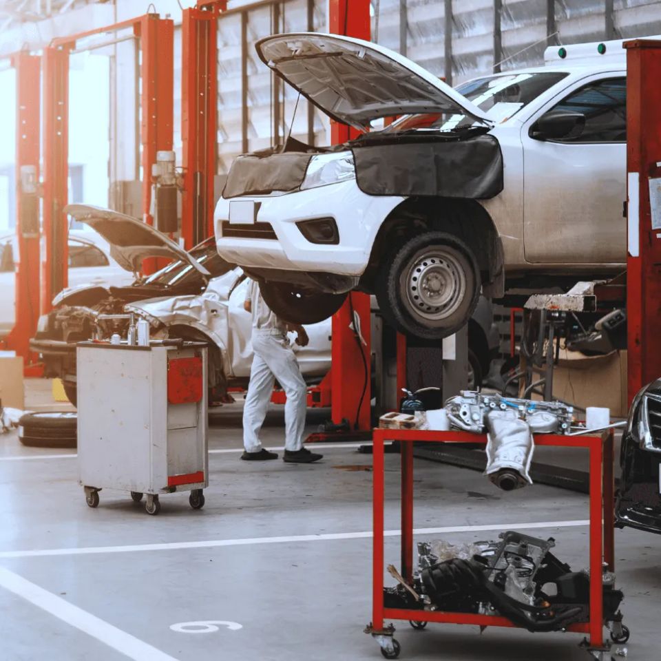 Mechanics working on vehicles in repair shop