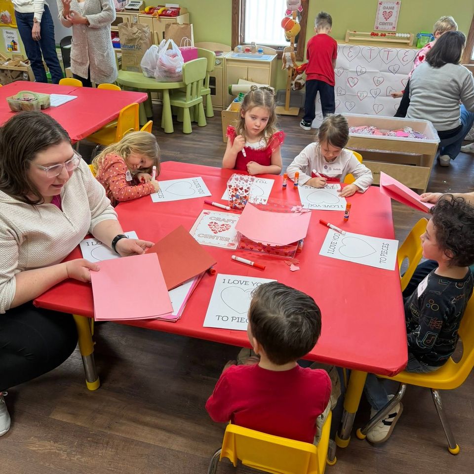 Teacher and 5 students sitting at a table