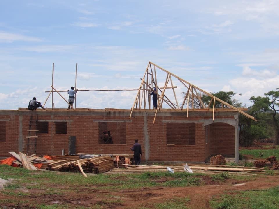Putting up roof support in uganda
