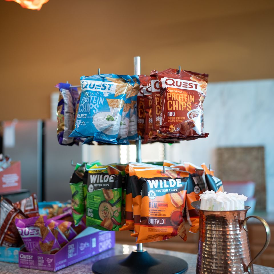 A variety of protein snacks on display behind the smoothie bar at Maximus Gym in Riverhead