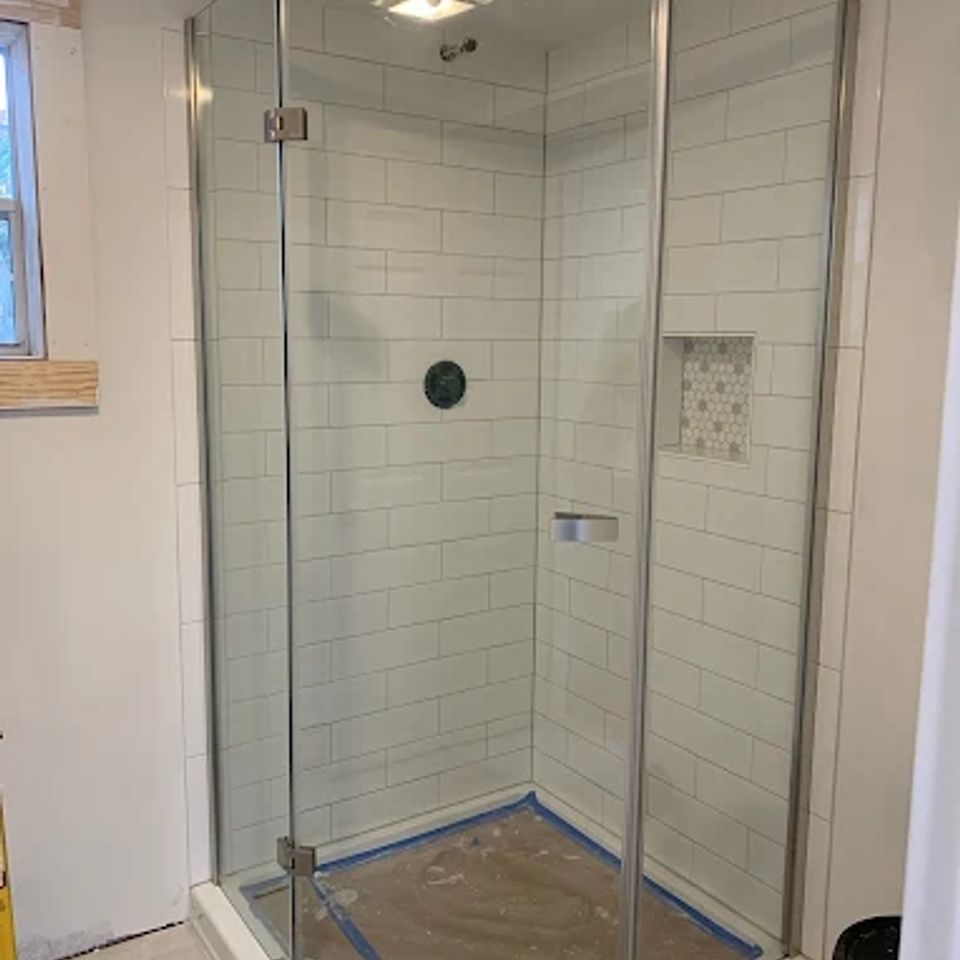 newly installed shower with glass door by Taurus Contracting Inc