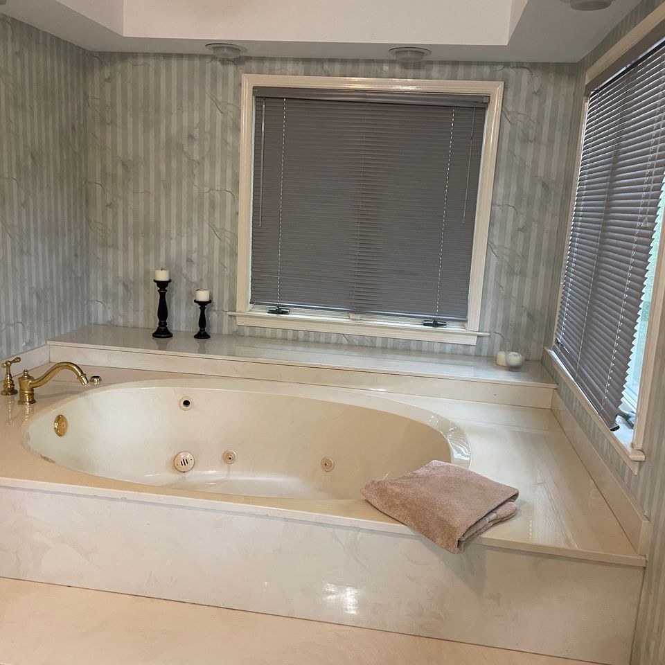 Spotless soaking tub and tiled surround after a house cleaning service in Virginia Beach VA