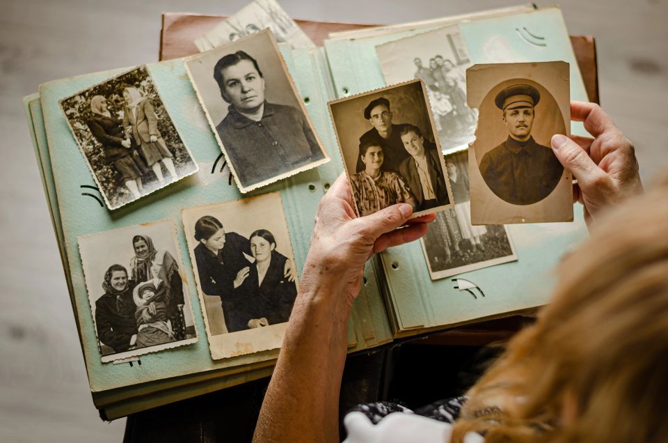 Female hands holding and old photo of her relatives
