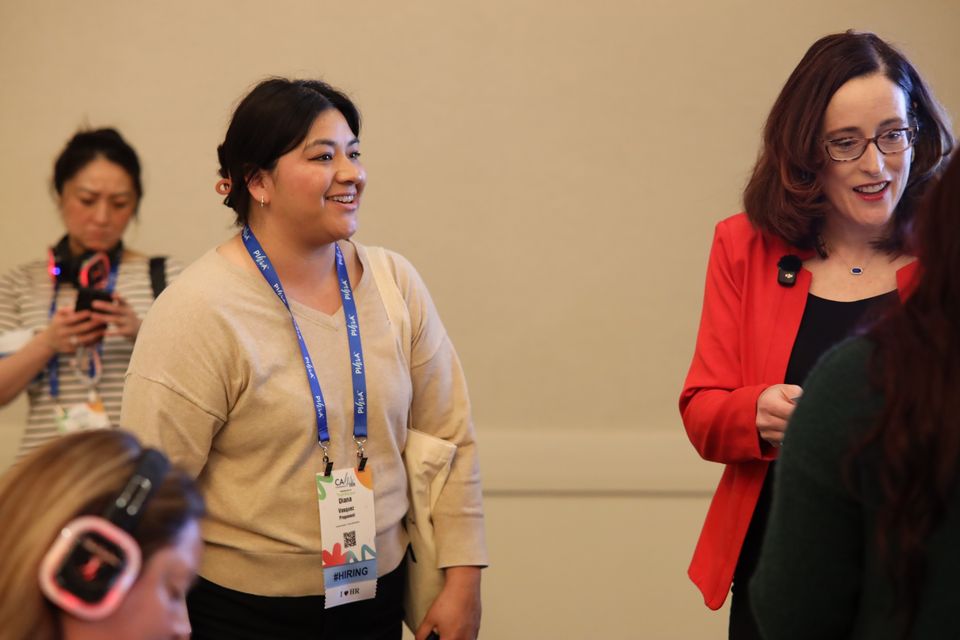Two women standing speaking