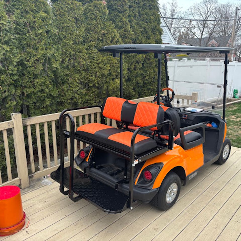 Back view of an orange golf cart rental from Mad Dog Golf Cart Rentals in Locust Lake PA