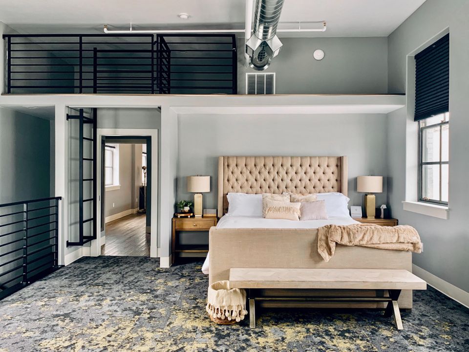 multi-layered bedroom with freshly made bed