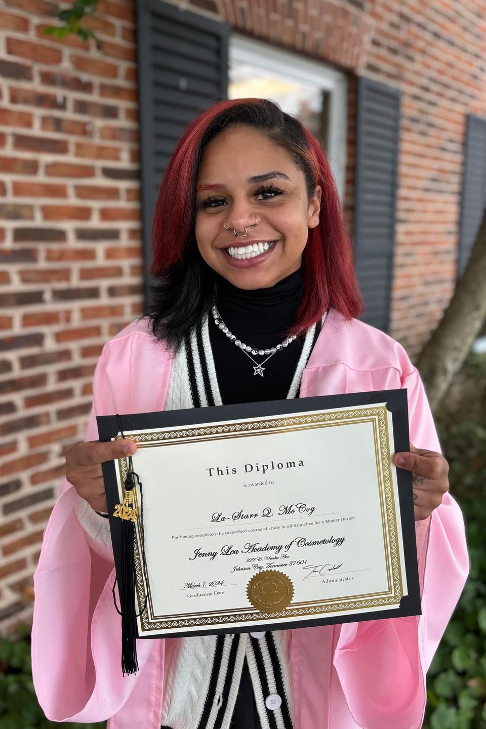 Beauty school graduate holding diploma after completing training program