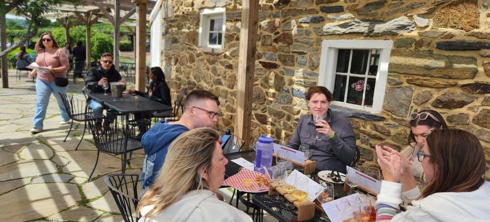 Group of people enjoying wine during a vineyard tour in Virginia