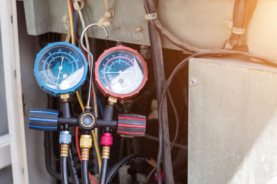 Air conditioner technician checks operation industrial air conditioners