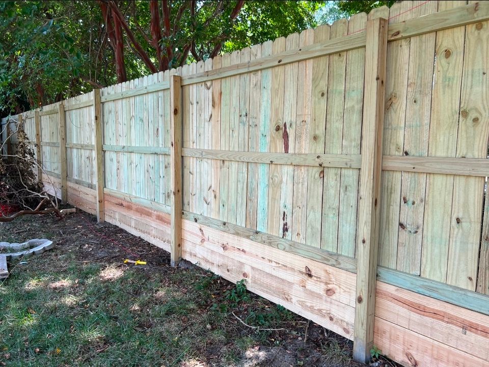 Wood privacy fence with kickboard installation along residential property line in Virginia Beach VA