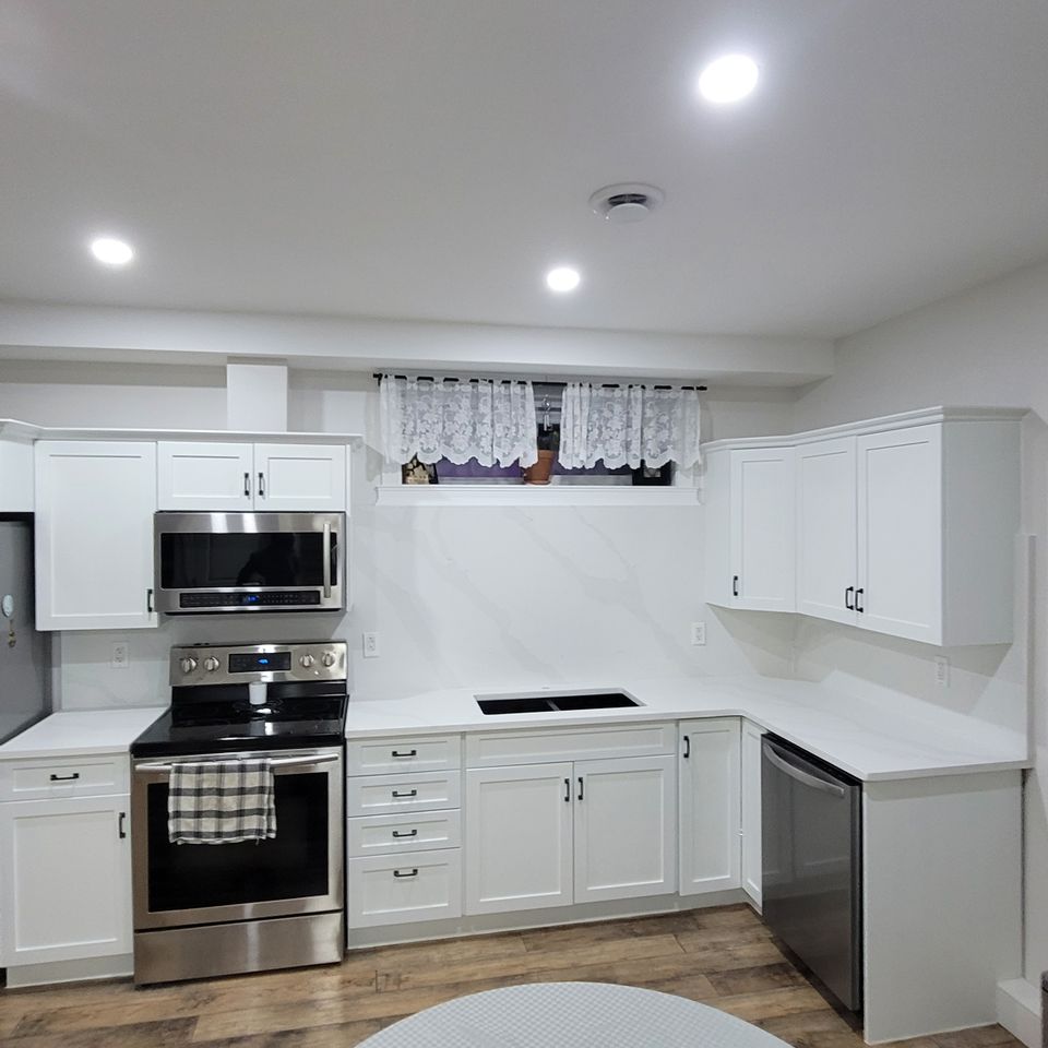 Bright kitchen with white countertop and tables