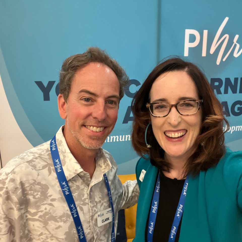 Man and woman posing for photo at an event