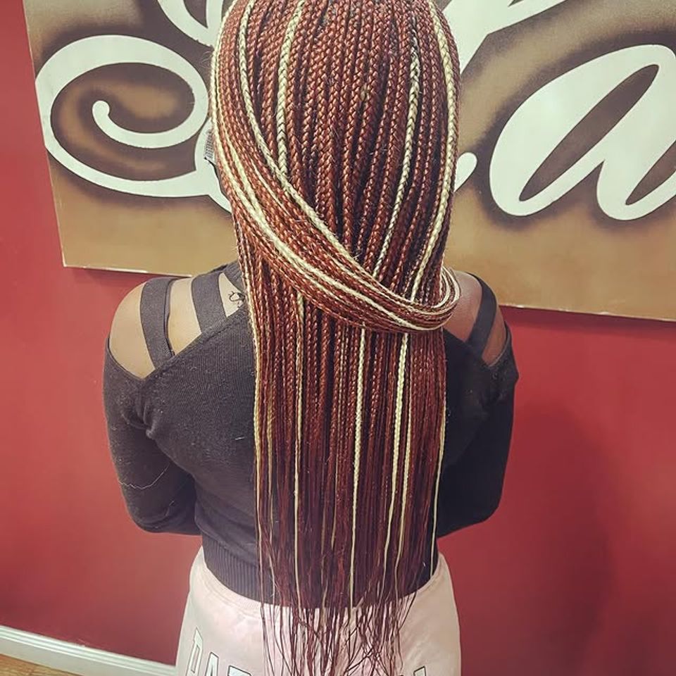 Long burgundy and blonde micro braids after a braiding service in Los Angeles CA