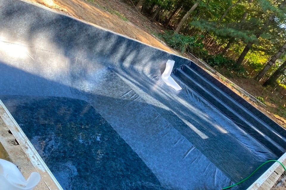 Dark liner installed in a rectangular inground pool during a liner replacement project