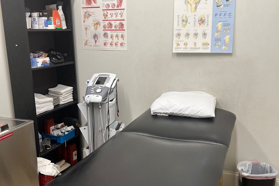 Private treatment room with a stimulation therapy machine at Mid-City Physical Therapy's New Orleans clinic