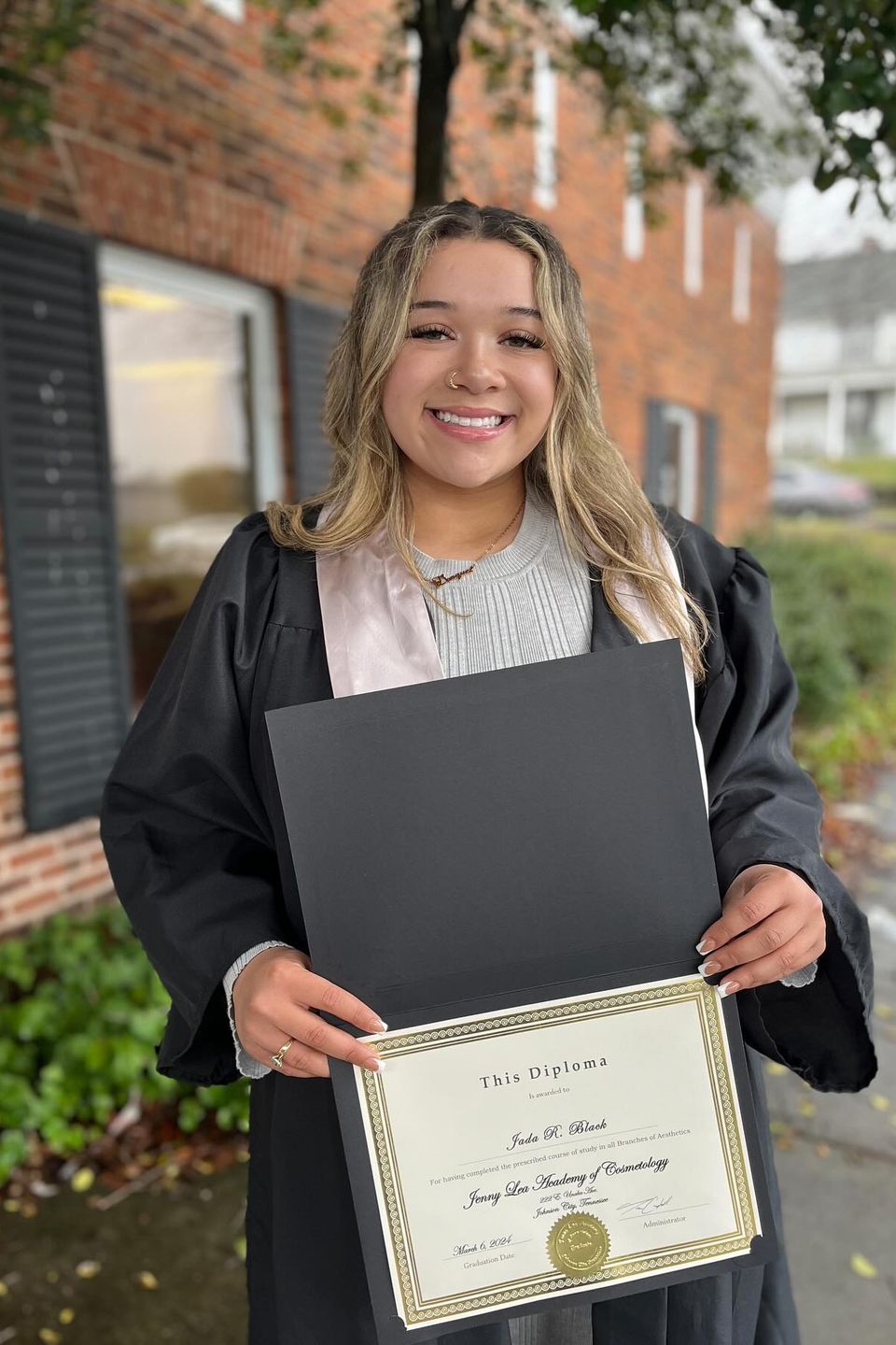 Esthetician program graduate holding certificate in Johnson City TN