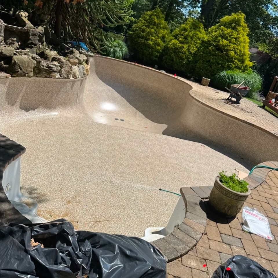 Freeform pool bottom stripped down to vermiculite base before new liner install on Long Island