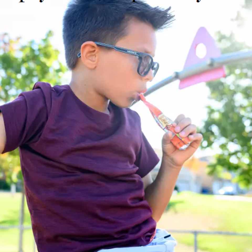 Kid eating yogurt from pouch