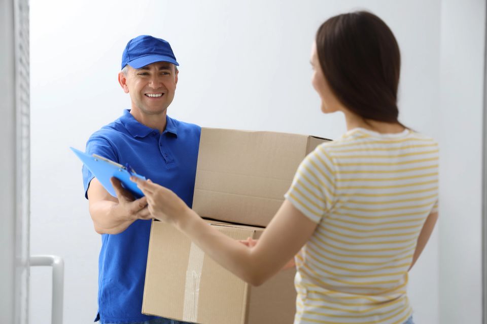A courier delivering packages to a woman