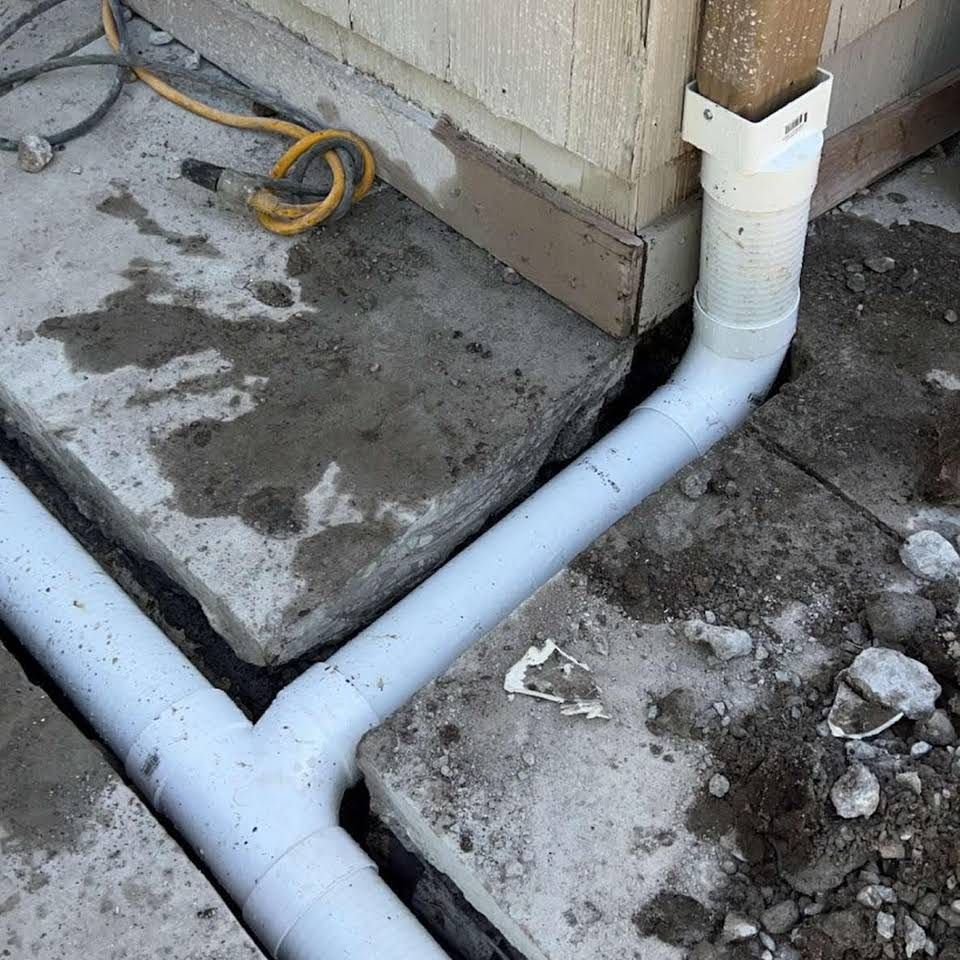 Cut out of concrete for gutter extension and driveway drain