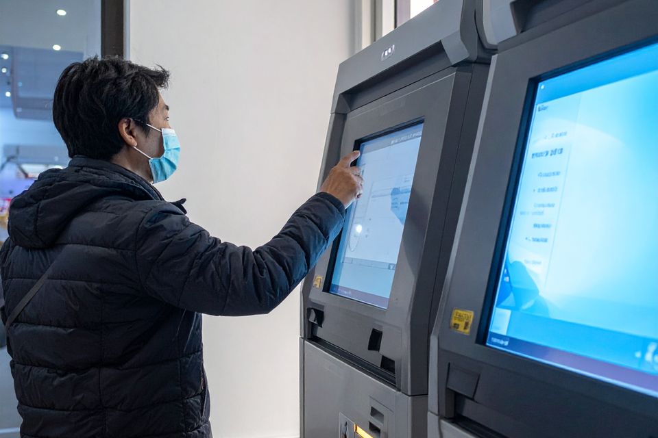 Firefly image someone using a kiosk in a cornerstore 545949