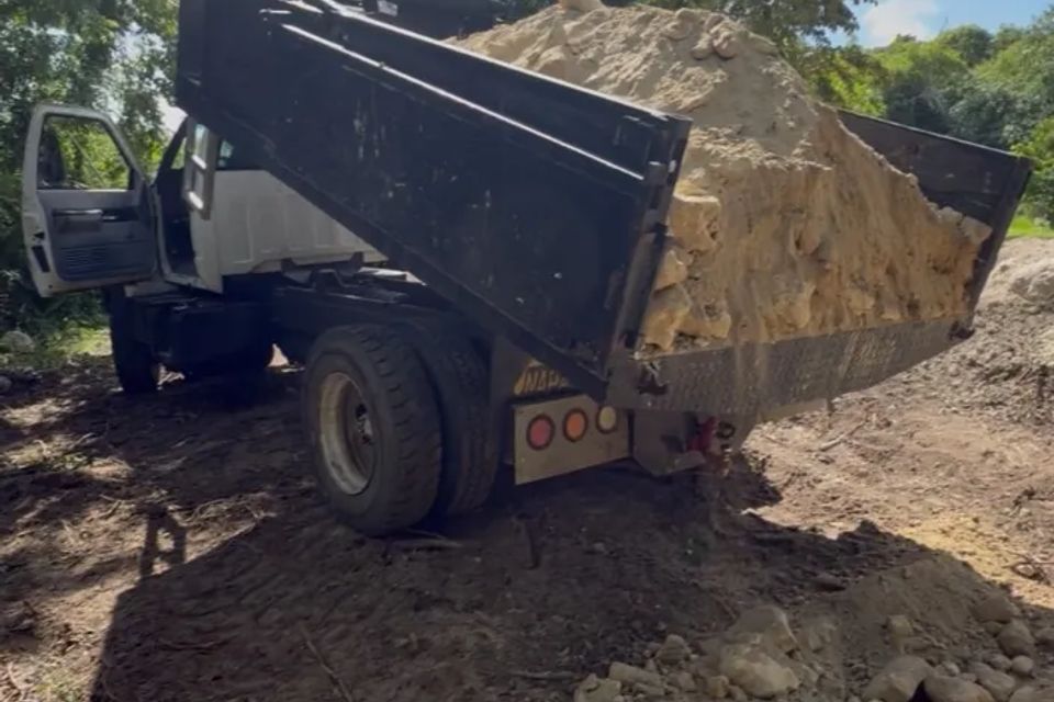 Dump truck unloading dirt