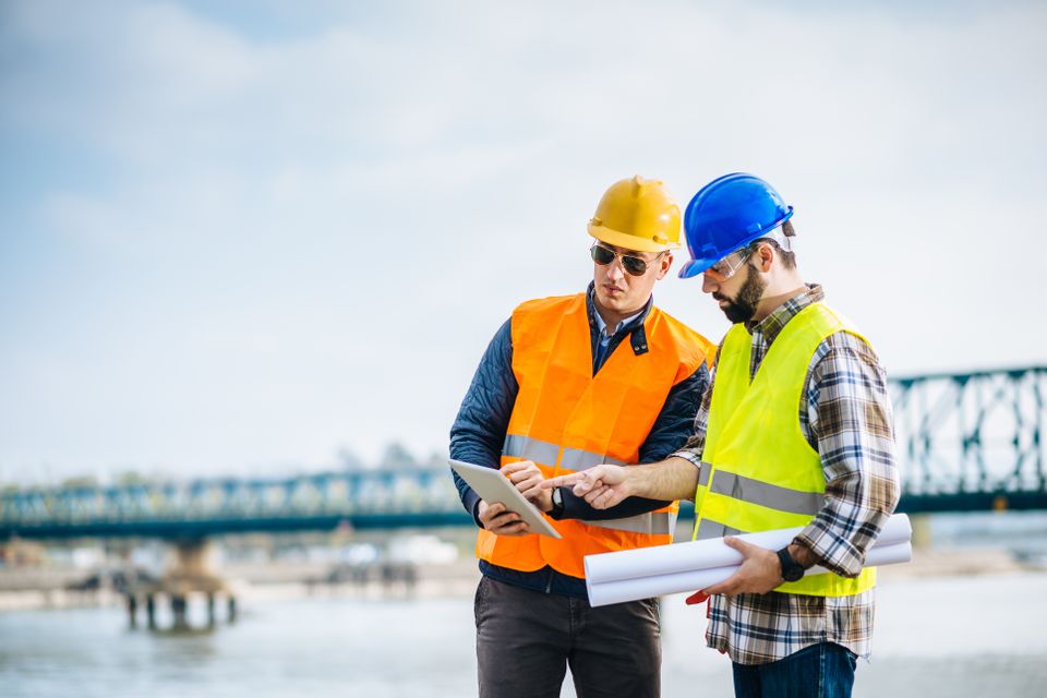 Construction workers with bridge in background istock 540857174