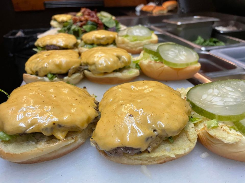 Cheeseburgers getting prepared from Inferno The Restaurant in Sound Beach