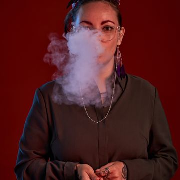 Young woman with electronic cigarette in hands blo 2023 11 27 05 04 20 utc copy