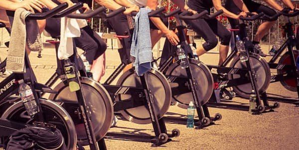 Spin class with all the participants lined up taken from the waist down 