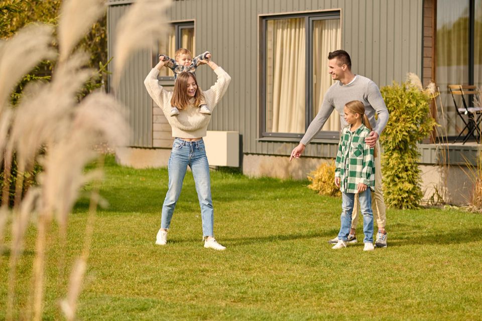 Family playing in front of their home 