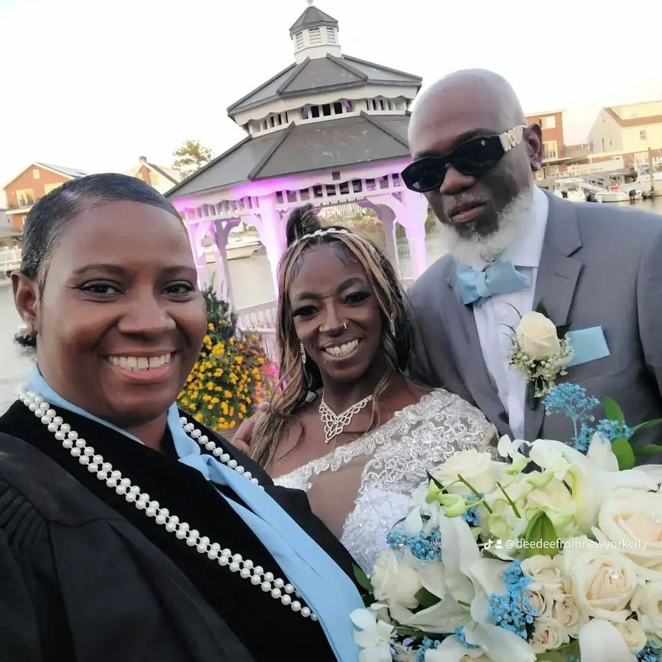 Wedding officiant Dee posing with newlyweds after ceremony in Queens New York