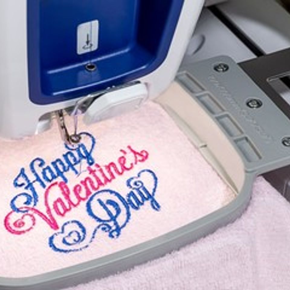 Embroidery machine sewing a design into a garment 