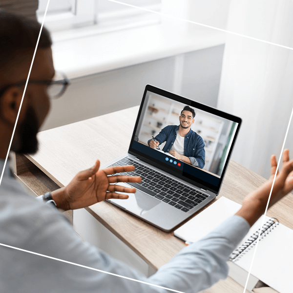 Man video chatting on laptop with another man