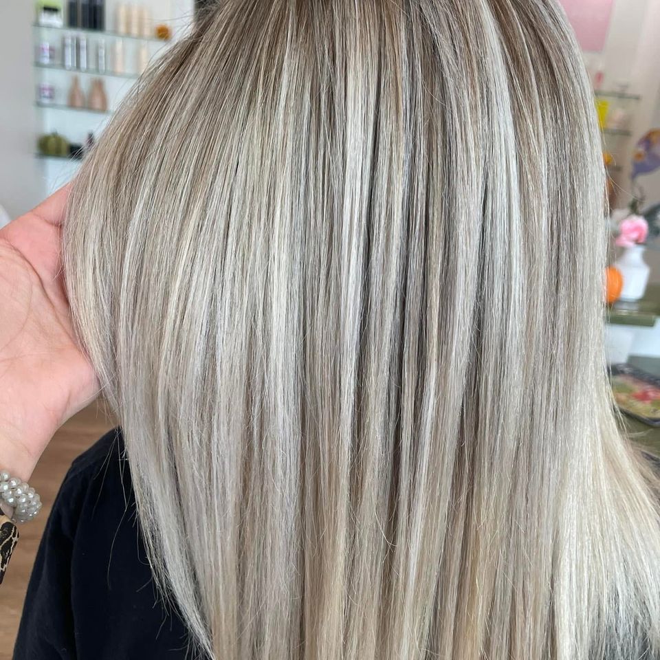 Sleek straight ash blonde hair with dimensional highlights after color service in Columbiana AL
