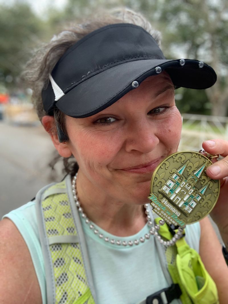 Laura Gary smiling with her running medal.