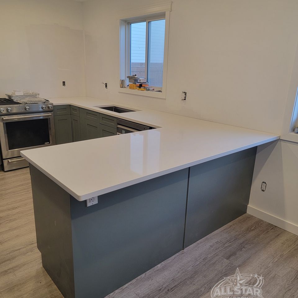 Gray kitchen island with white stone countertop installation in Houston, TX
