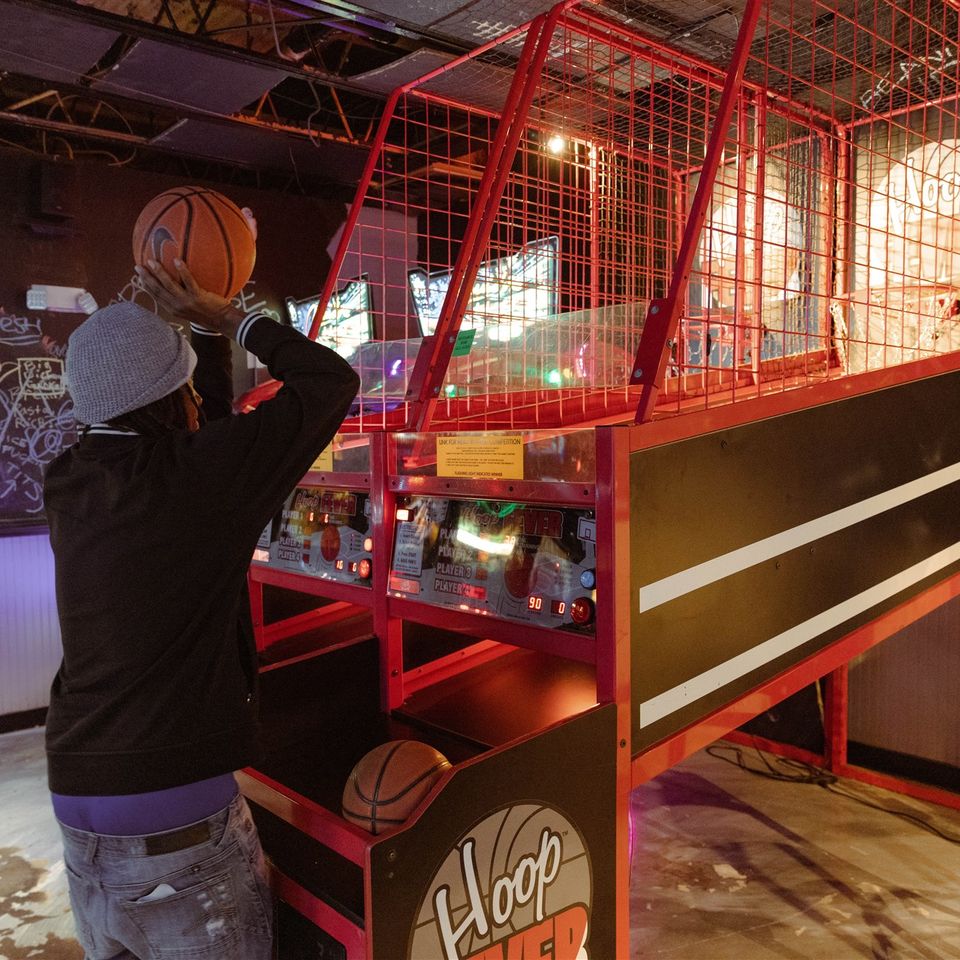Gentleman playing basketball arcade game