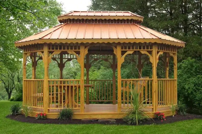Wood gazebo with two tier cedar roof and railings in a landscaped Knoxville TN yard