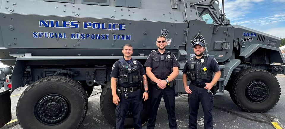 Niles Police officers standing in front of a Special Response Team vehicle during the DSAV Buddy Walk.