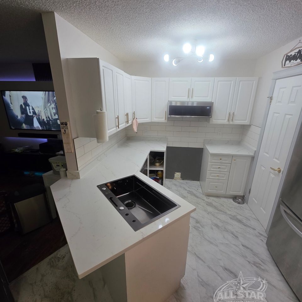 Kitchen island with custom stone countertops and backsplash installation Houston, TX