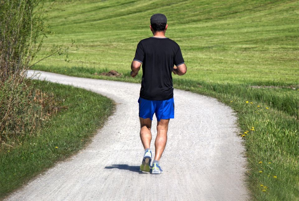 Male jogging in summer heat. In Houston, Texas park 