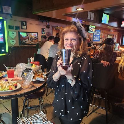 Woman holding a Kentucky Derby-themed cup during the 2025 Kentucky Derby event at JR's.