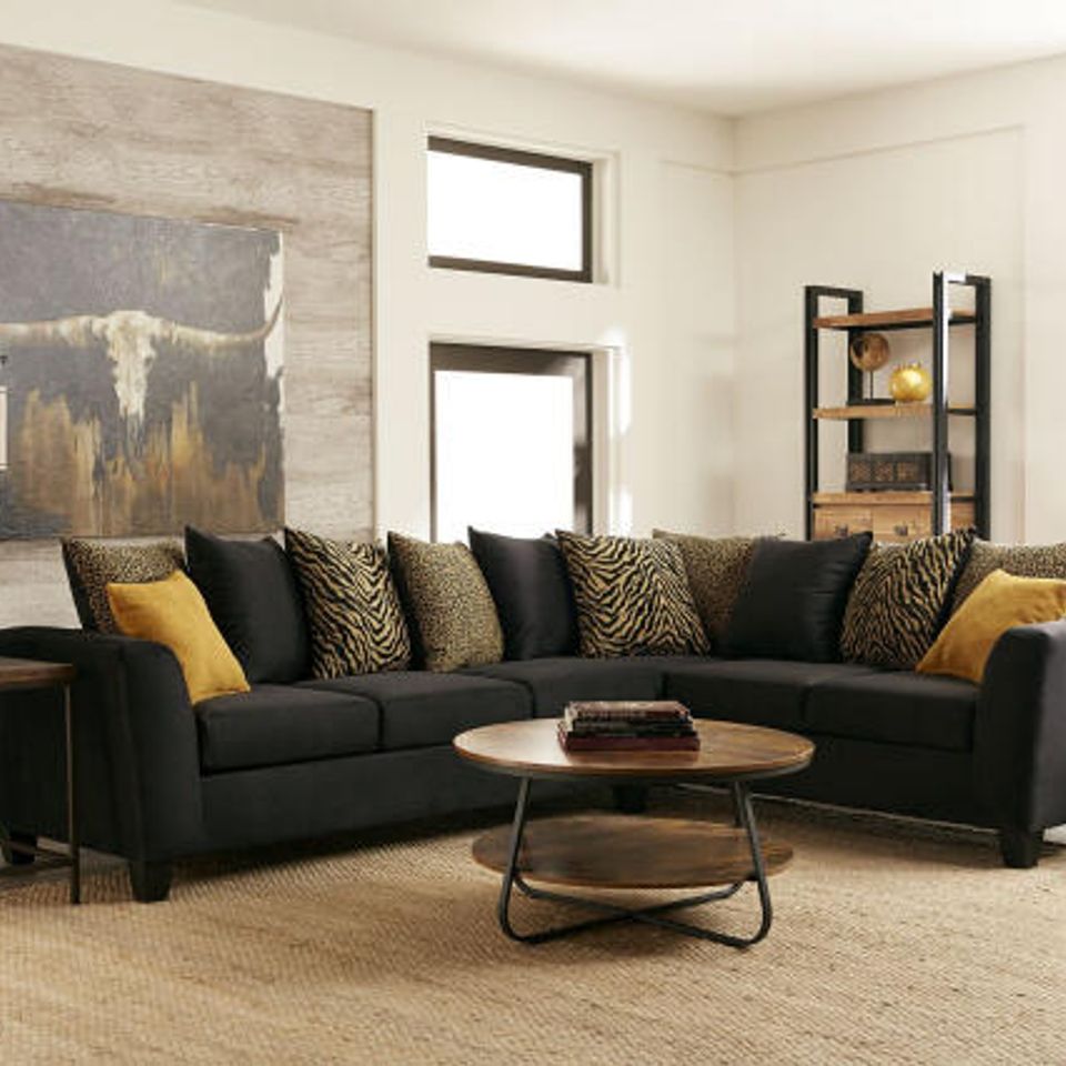 Black sectional yellow pillows